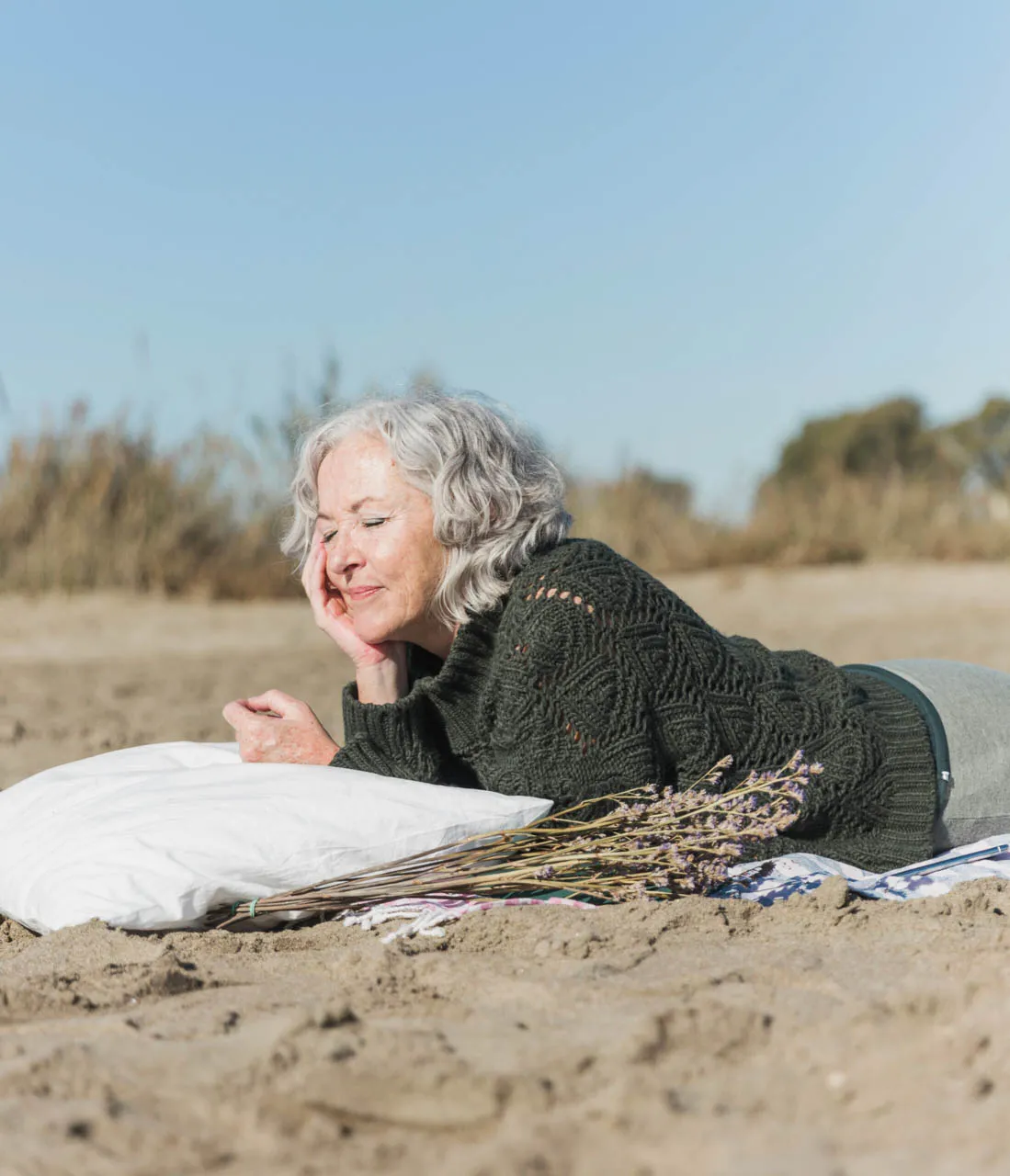 medium shot woman with pillow beach scaled 1
